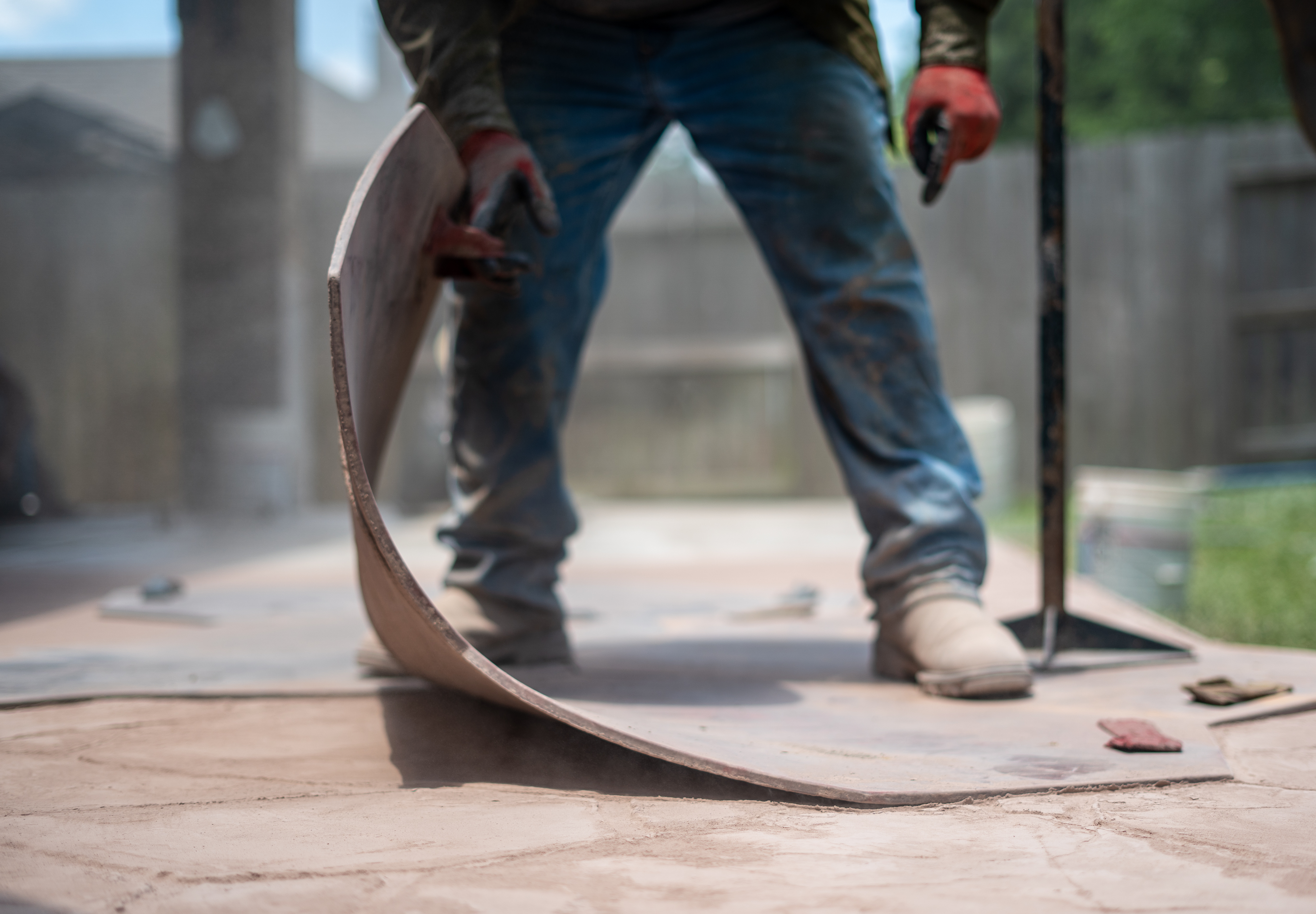 Man placing a stamp onto concrete